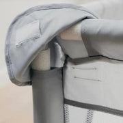 Close-up of the padded top rail and corner joint of the play yard