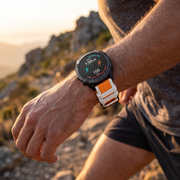 Deadtree Dual Track 26mm strap on a runner's wrist on a mountain trail
