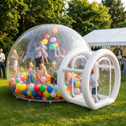 Guests playing with balloons inside the 4m bubble house at a garden party