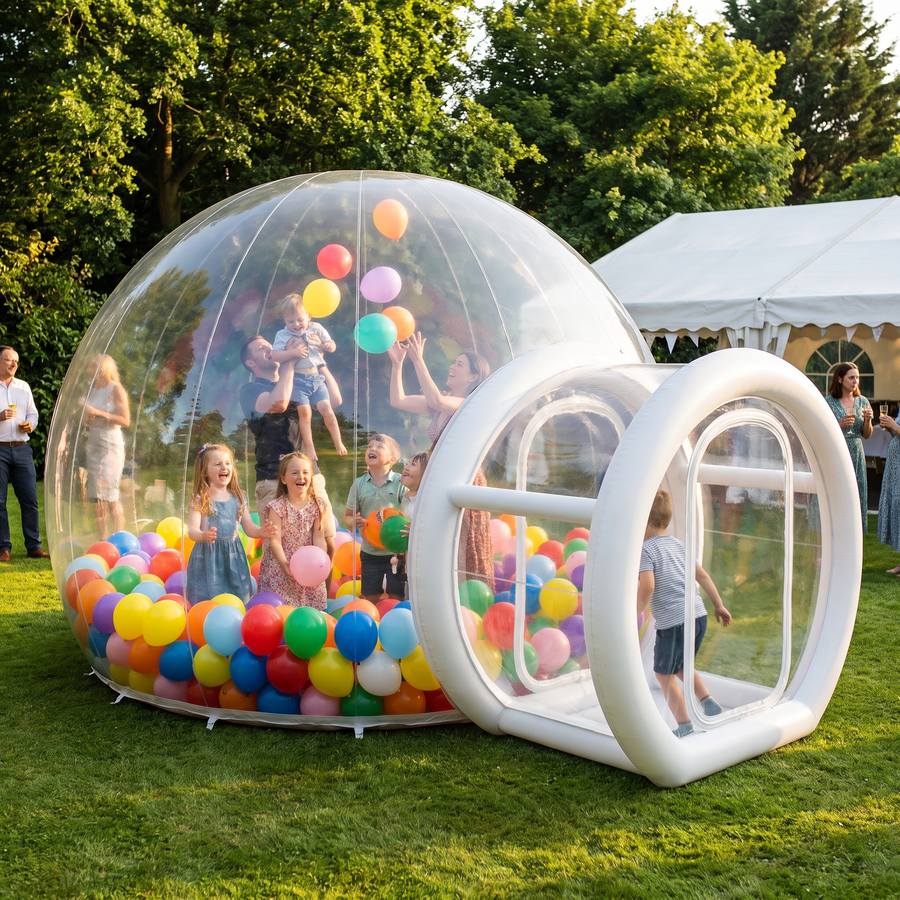 Guests playing with balloons inside the 4m bubble house at a garden party