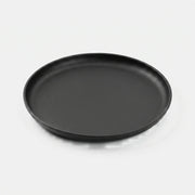 Cast iron plate, studio product shot on grey with cast shadow