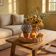 Woven wicker round tray on a coffee table in a Tuscan lounge with lavender and sunflowers