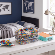 Multi stackable 3 layer block organizer open on a desk in a modern boys bedroom