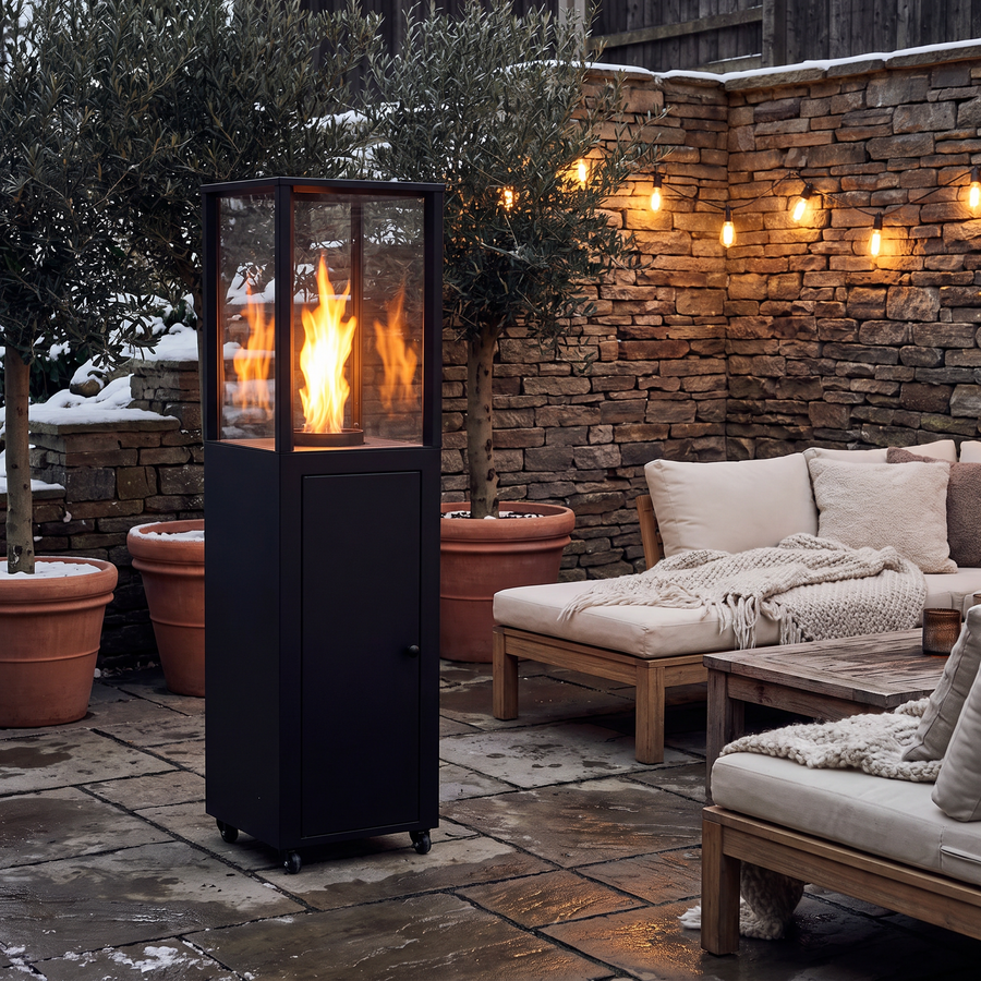 Ember wood pellet heater burning in a stone courtyard lounge on a winter evening