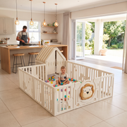 Toddler playing with balls in the Little Lion Playpen in an open-plan family home