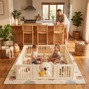 Two siblings playing in the Little Koala Playpen in an open-plan family kitchen