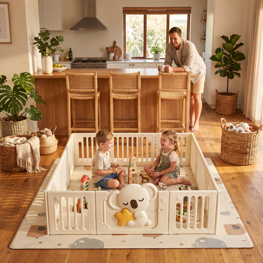 Two siblings playing in the Little Koala Playpen in an open-plan family kitchen