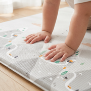 Little hands pressing into the soft Alpine Peaks play mat