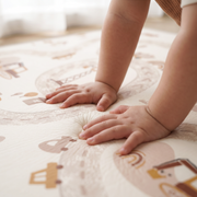 Little hands pressing into the soft Road Rascals play mat