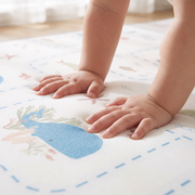 Little hands pressing into the soft Whale Tale play mat