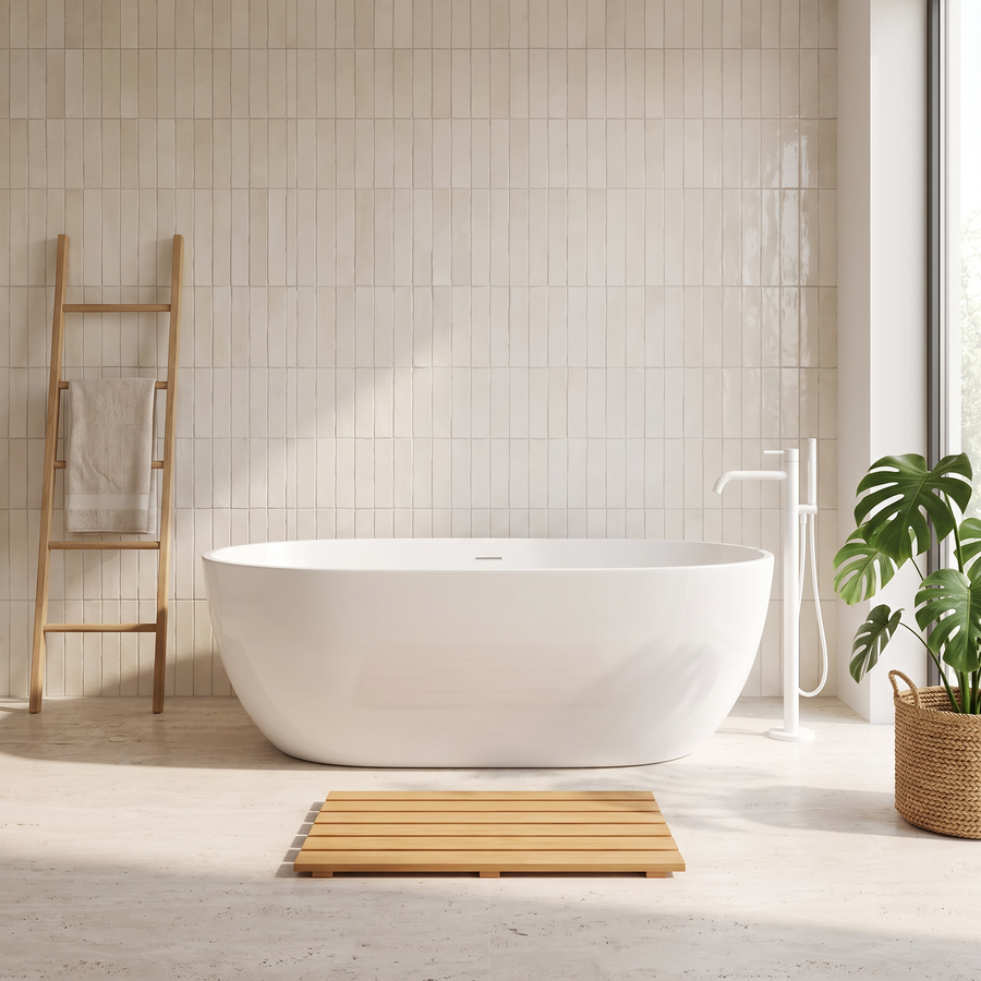 Light wood slatted bath mat in front of a white freestanding bath in a bright modern bathroom
