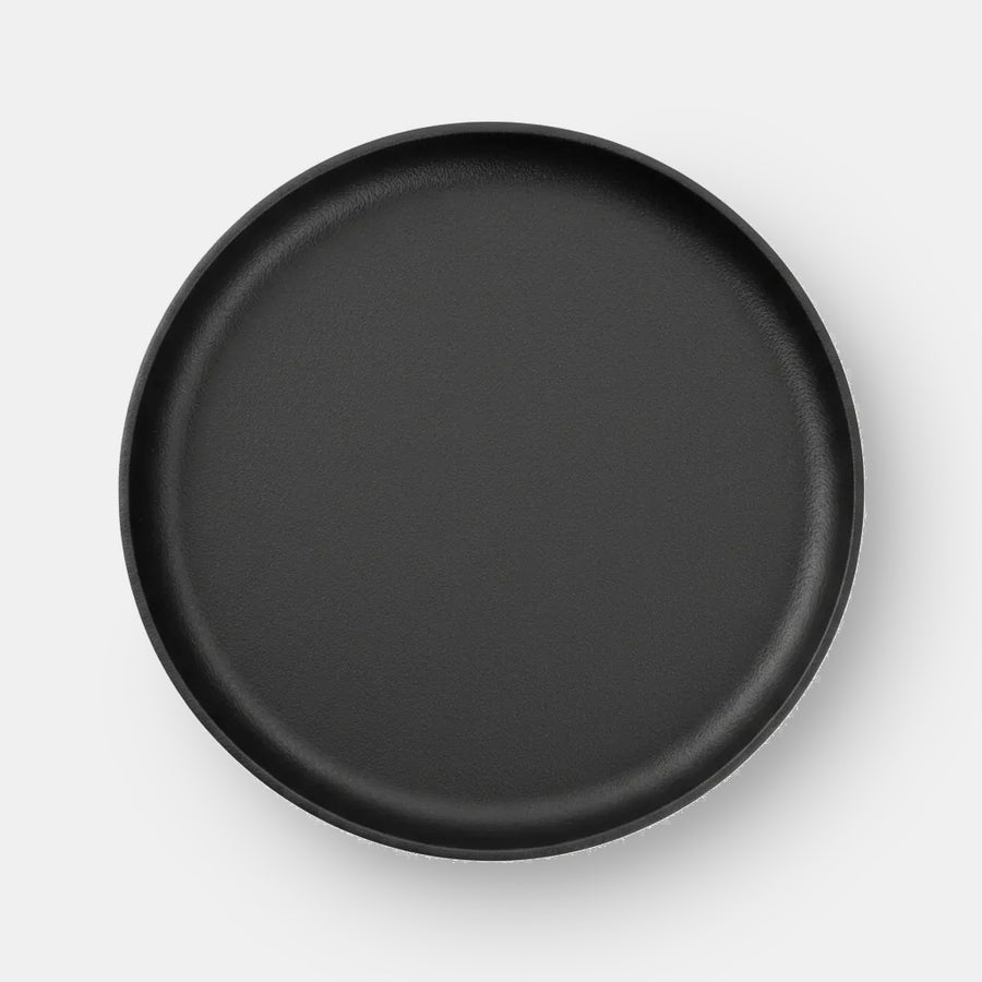 Cast Iron Plate on a light grey studio backdrop with a soft cast shadow