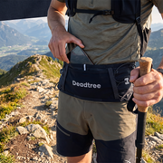 Hiker putting a phone into the Deadtree Stash Pack