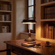 Banker's desk lamp on a writing desk in a Tuscan study