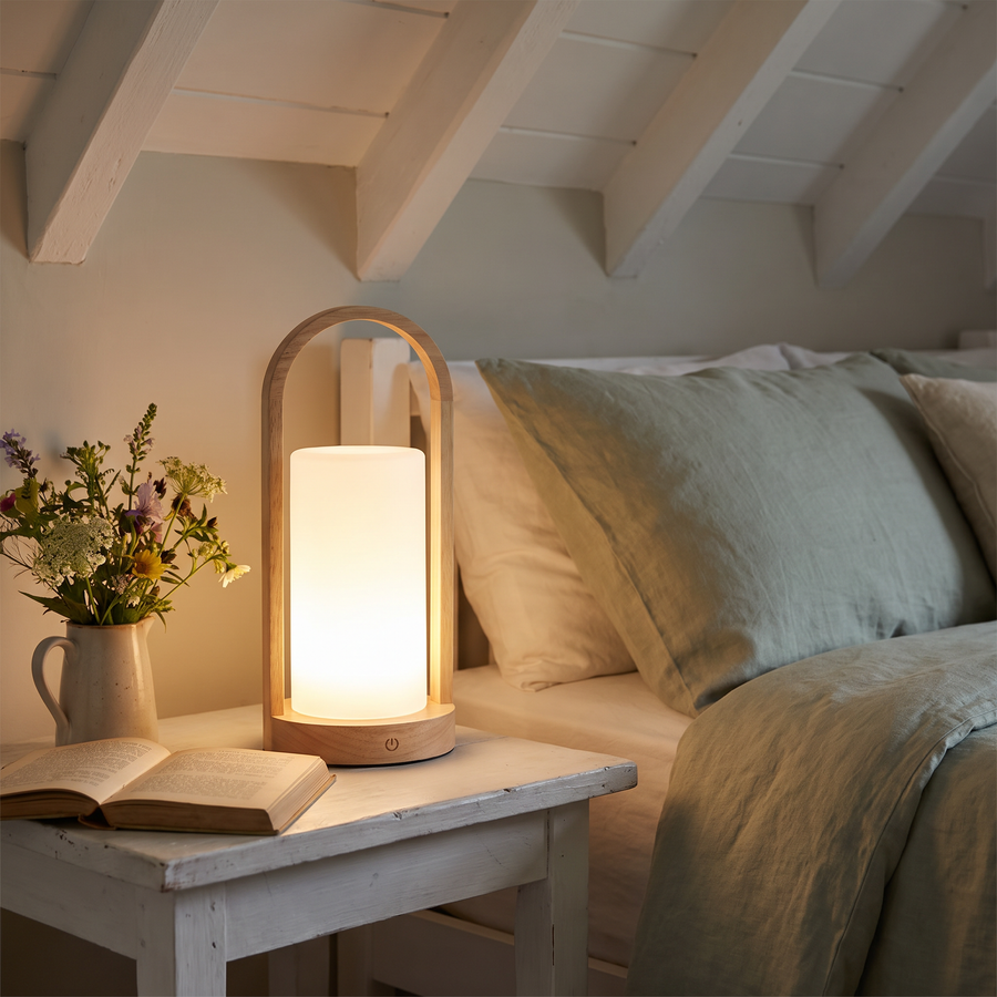 Glimmer wood lantern on a cottage bedside table