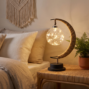 Moonlit table lamp on a rattan bedside table