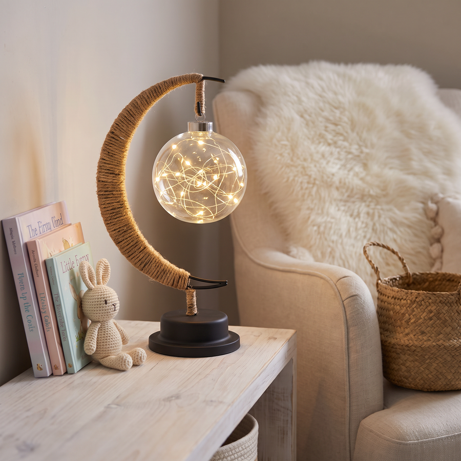 Moonlit table lamp on a nursery shelf