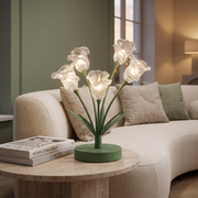Tulip glass table lamp on a living room side table